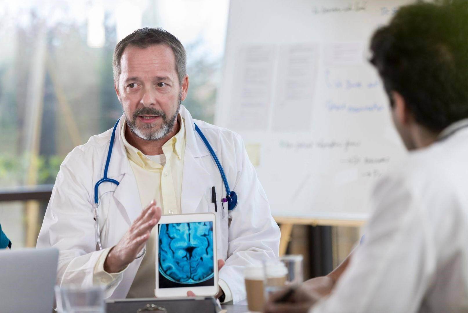 a neurologist accident doctor shows a patient their brain scan in Brentwood, Tennessee