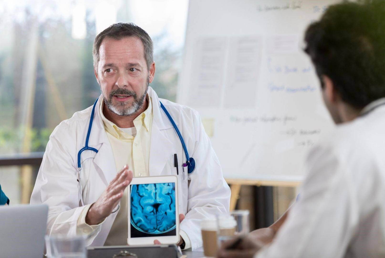 a neurologist accident doctor shows a patient their brain scan in Knoxville, Tennessee