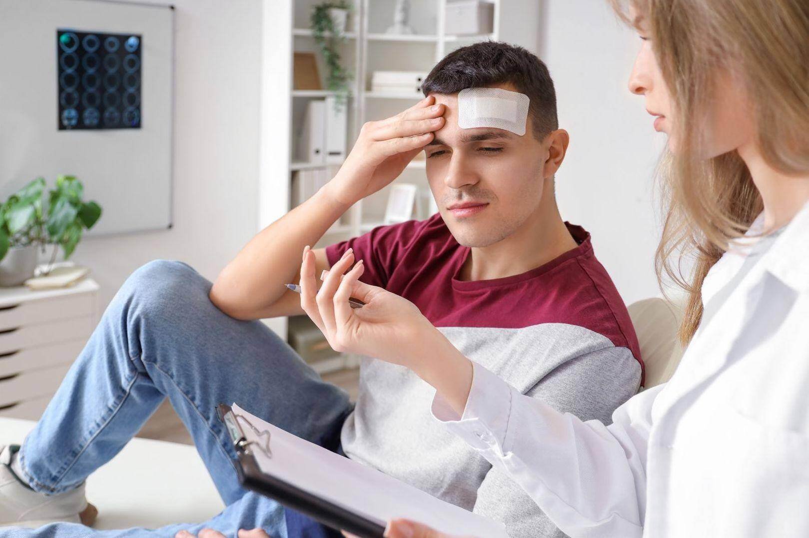 A car accident victim getting medical advice from a car accident doctor in Midland, Texas