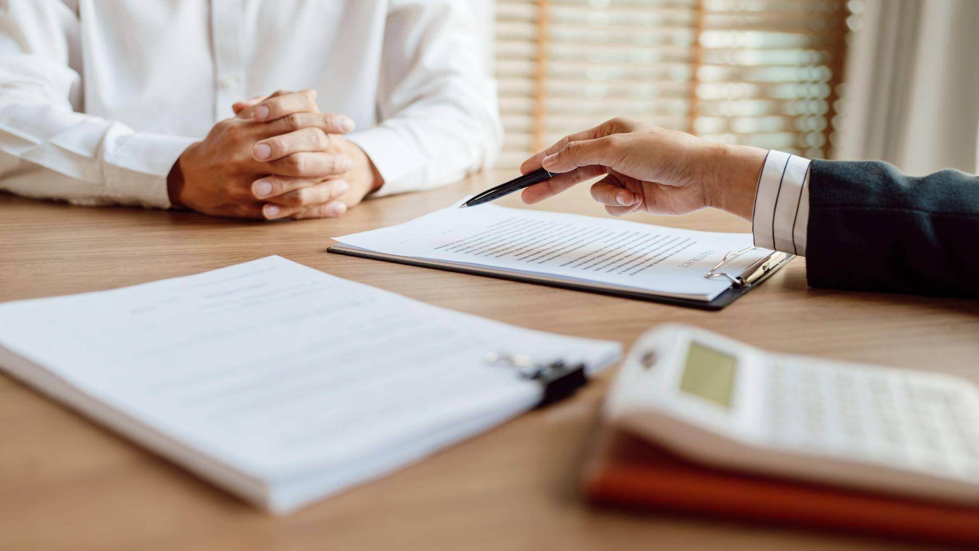 Life care planner meeting with customer with folded hands in Milton, Georgia.