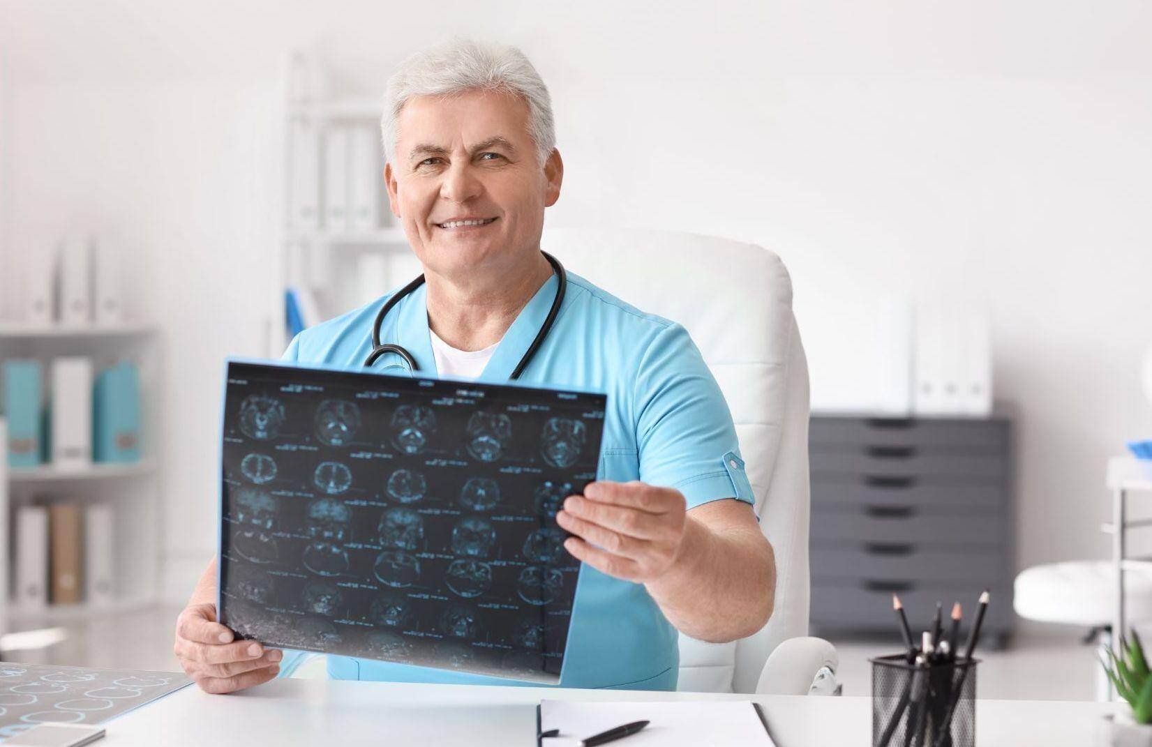 An older neurologist reviewing a brain scan in Surprise, Arizona