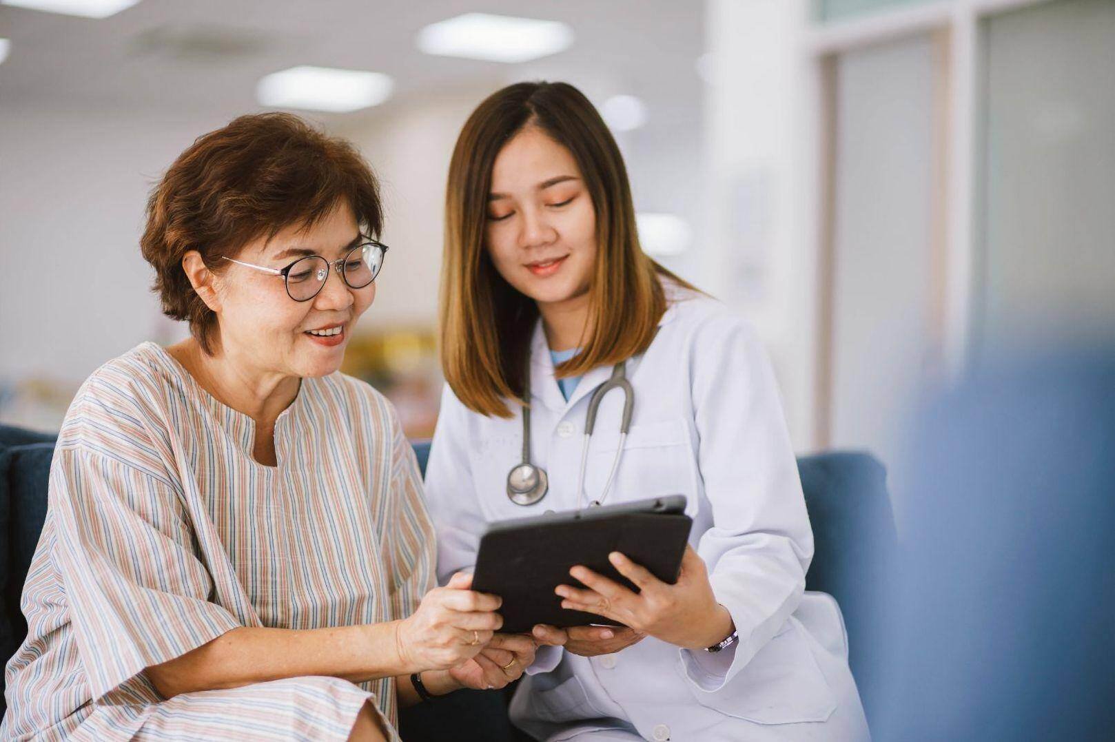 An older patient and a neurologist review a medical chart in Lakewood, Ohio