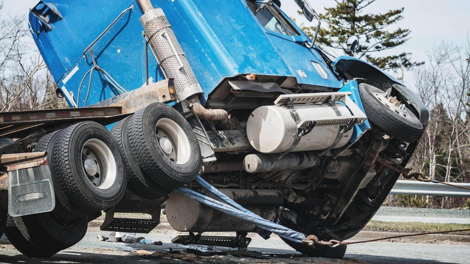 Leaning blue truck inspected by truck accident lawyers in Saginaw, Michigan